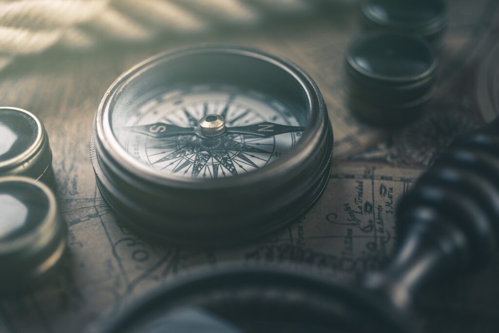 Zoomed in Compass in focus, against a retro map